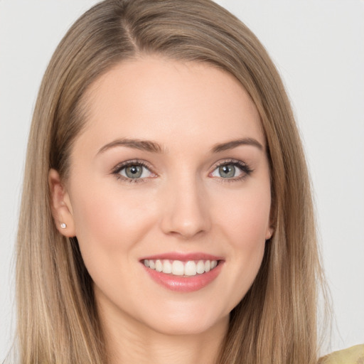 Joyful white young-adult female with long  brown hair and grey eyes