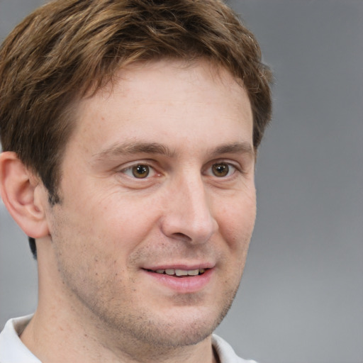 Joyful white adult male with short  brown hair and grey eyes