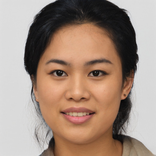 Joyful asian young-adult female with medium  black hair and brown eyes
