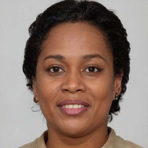 Joyful latino adult female with short  brown hair and brown eyes