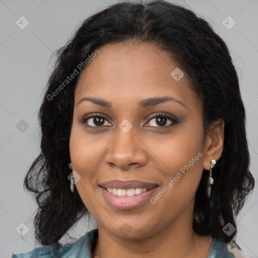 Joyful black young-adult female with long  brown hair and brown eyes