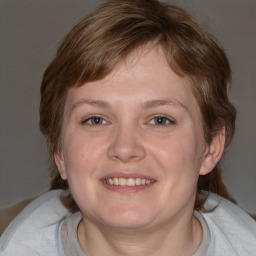 Joyful white young-adult female with medium  brown hair and blue eyes