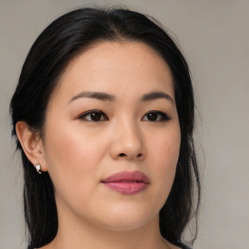 Joyful asian young-adult female with medium  black hair and brown eyes