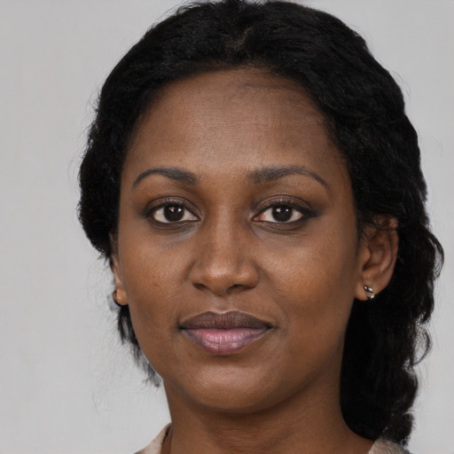 Joyful black young-adult female with medium  black hair and brown eyes