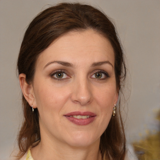 Joyful white young-adult female with medium  brown hair and grey eyes