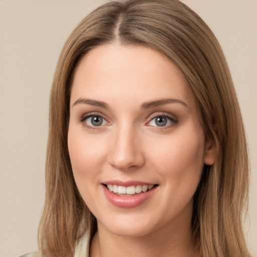 Joyful white young-adult female with long  brown hair and green eyes