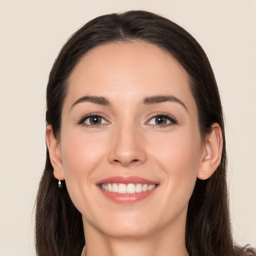 Joyful white young-adult female with long  brown hair and brown eyes