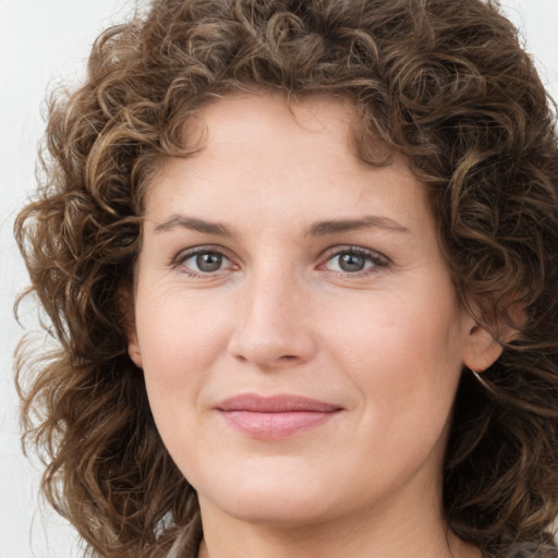 Joyful white young-adult female with medium  brown hair and green eyes