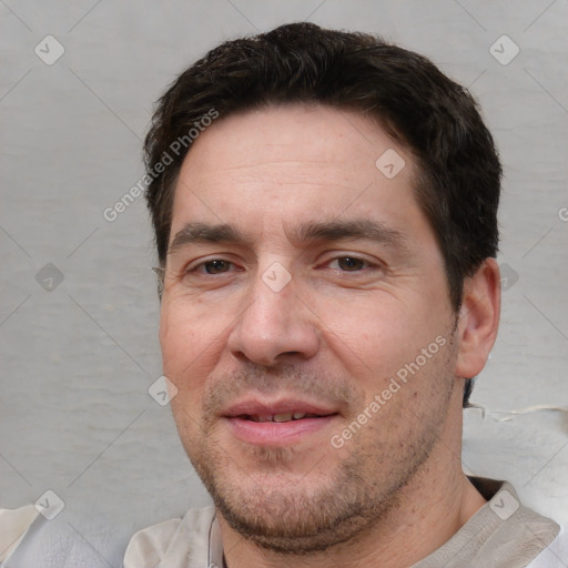 Joyful white adult male with short  brown hair and brown eyes