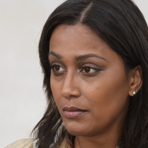 Neutral black young-adult female with long  brown hair and brown eyes