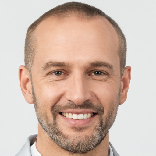 Joyful white adult male with short  brown hair and brown eyes