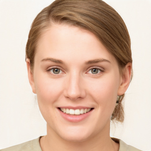 Joyful white young-adult female with medium  brown hair and green eyes