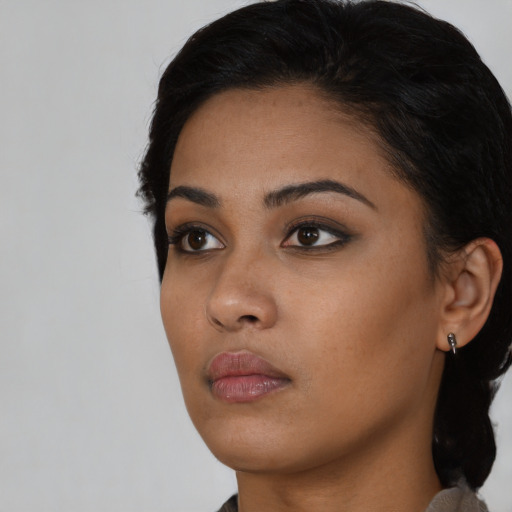 Neutral black young-adult female with long  black hair and brown eyes