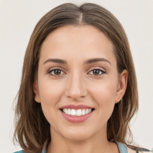 Joyful white young-adult female with long  brown hair and grey eyes