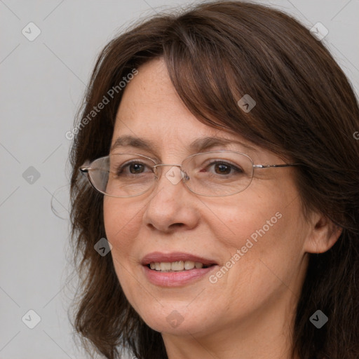 Joyful white adult female with long  brown hair and grey eyes