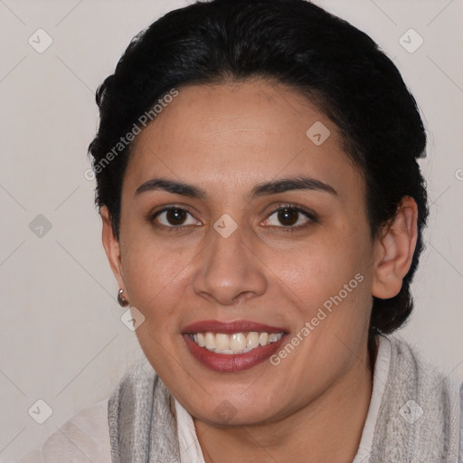 Joyful latino young-adult female with short  black hair and brown eyes