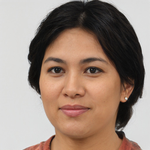 Joyful asian adult female with medium  brown hair and brown eyes