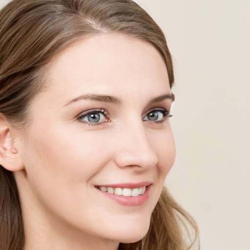 Joyful white young-adult female with long  brown hair and grey eyes