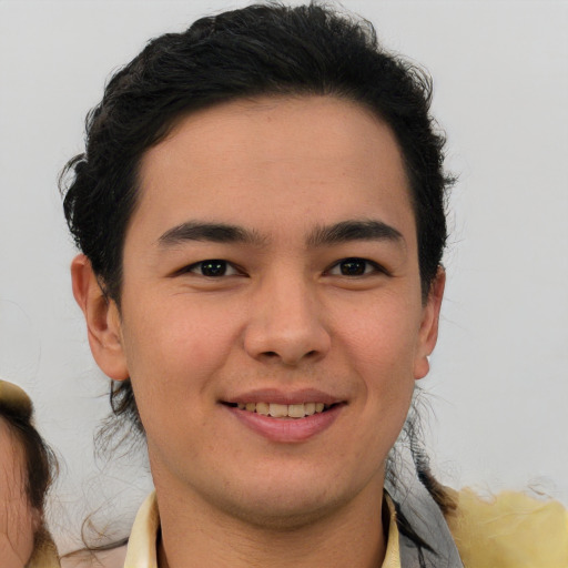 Joyful asian young-adult male with short  brown hair and brown eyes