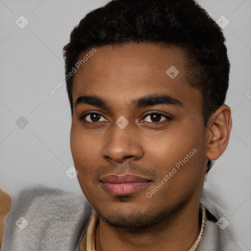 Joyful black young-adult male with short  black hair and brown eyes