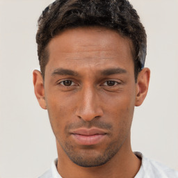 Joyful black young-adult male with short  brown hair and brown eyes