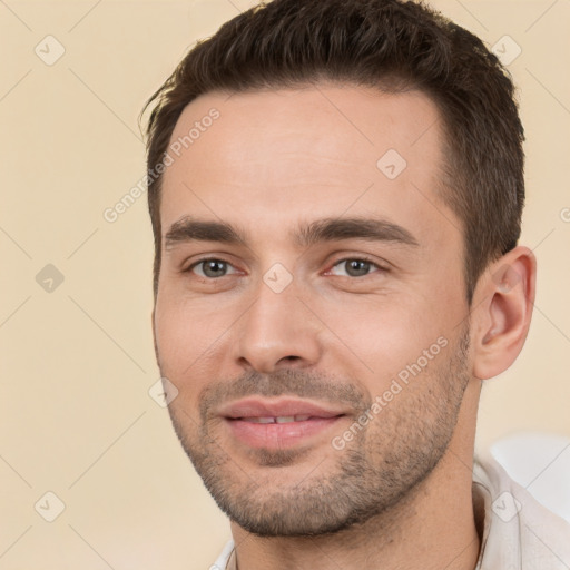 Joyful white young-adult male with short  brown hair and brown eyes