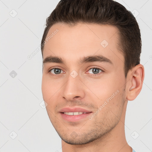 Joyful white young-adult male with short  brown hair and brown eyes