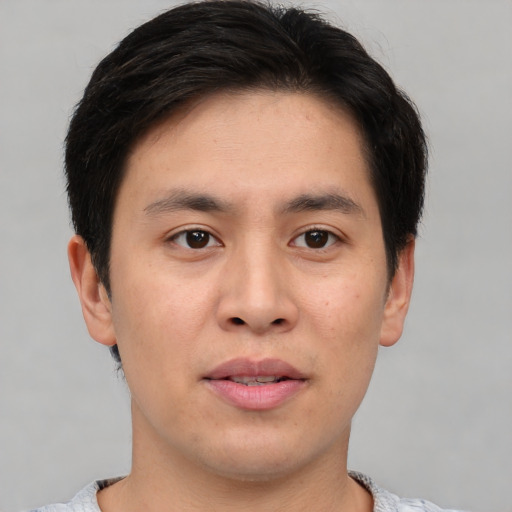 Joyful asian young-adult male with short  brown hair and brown eyes
