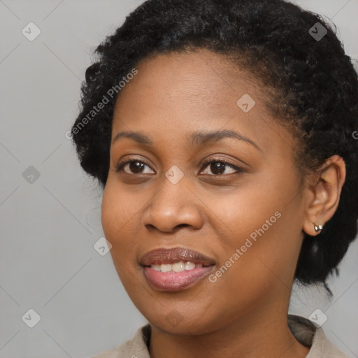 Joyful black young-adult female with medium  black hair and brown eyes