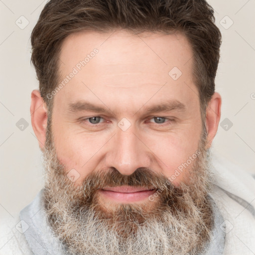 Joyful white adult male with short  brown hair and grey eyes