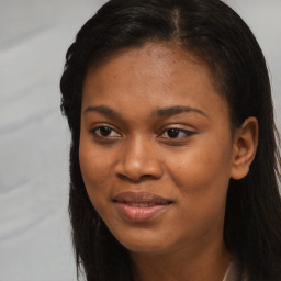 Joyful black young-adult female with long  brown hair and brown eyes