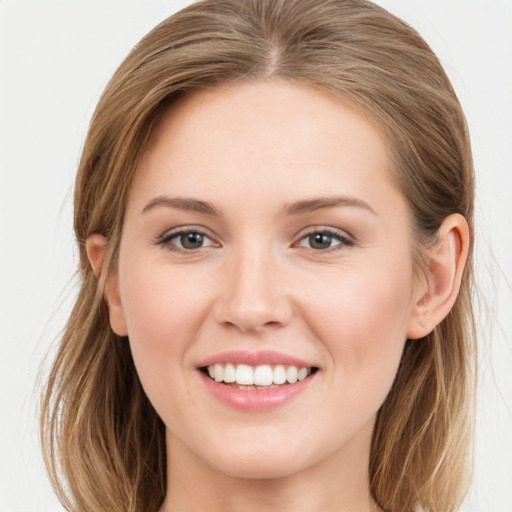 Joyful white young-adult female with long  brown hair and grey eyes