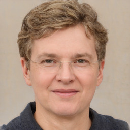 Joyful white adult male with short  brown hair and grey eyes