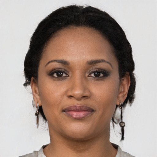 Joyful black young-adult female with medium  brown hair and brown eyes