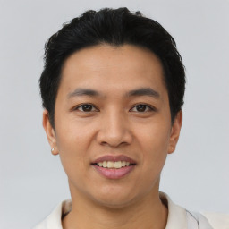 Joyful asian young-adult male with short  black hair and brown eyes