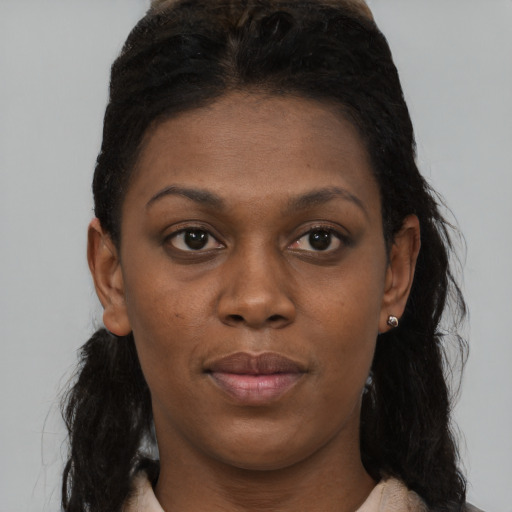Joyful black young-adult female with short  brown hair and brown eyes