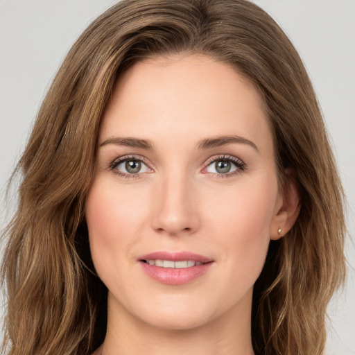 Joyful white young-adult female with long  brown hair and green eyes