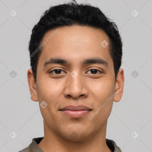 Joyful latino young-adult male with short  black hair and brown eyes