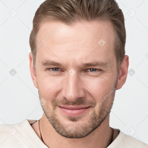 Joyful white young-adult male with short  brown hair and grey eyes