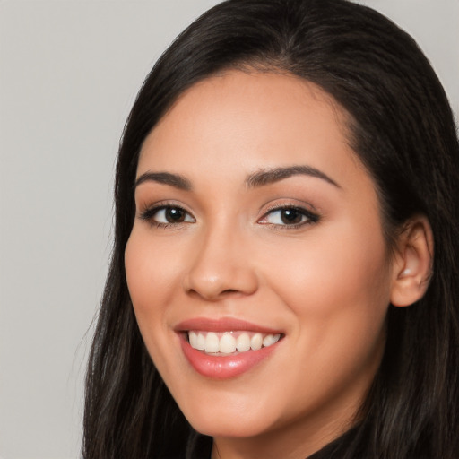 Joyful white young-adult female with long  black hair and brown eyes