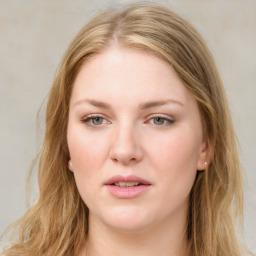 Joyful white young-adult female with long  brown hair and blue eyes