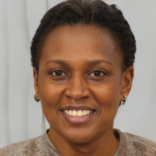 Joyful black adult female with short  brown hair and brown eyes