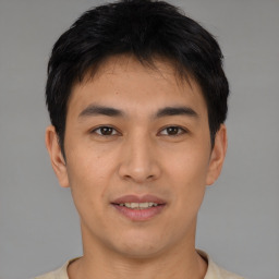 Joyful asian young-adult male with short  black hair and brown eyes