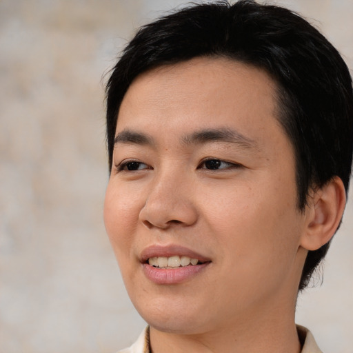 Joyful asian young-adult male with medium  black hair and brown eyes