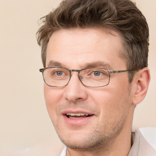 Joyful white adult male with short  brown hair and brown eyes