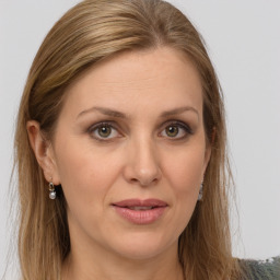 Joyful white adult female with long  brown hair and grey eyes