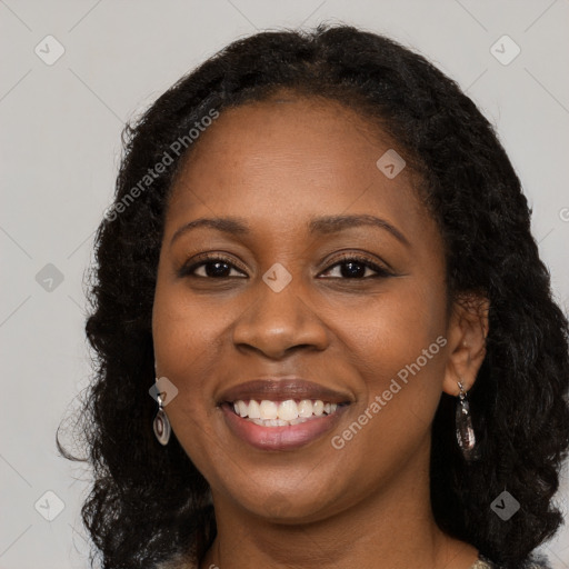 Joyful black young-adult female with long  brown hair and brown eyes