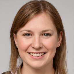 Joyful white young-adult female with medium  brown hair and grey eyes