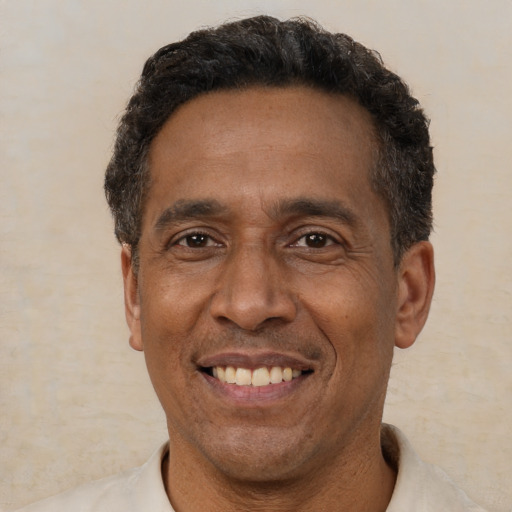 Joyful latino adult male with short  black hair and brown eyes