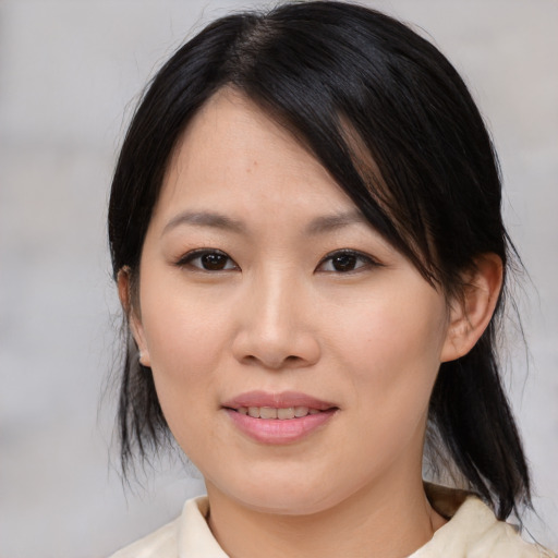 Joyful asian young-adult female with medium  black hair and brown eyes